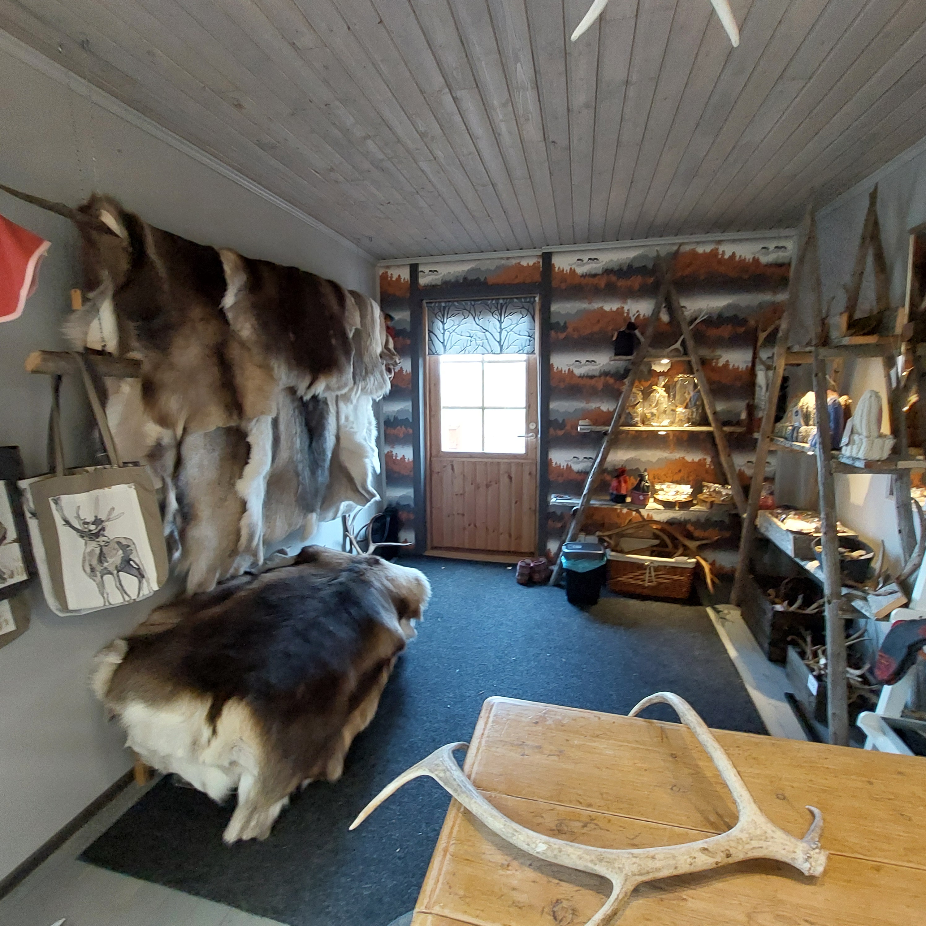 Shelves of handmade reindeer leather pouches, wool mittens and antler knives